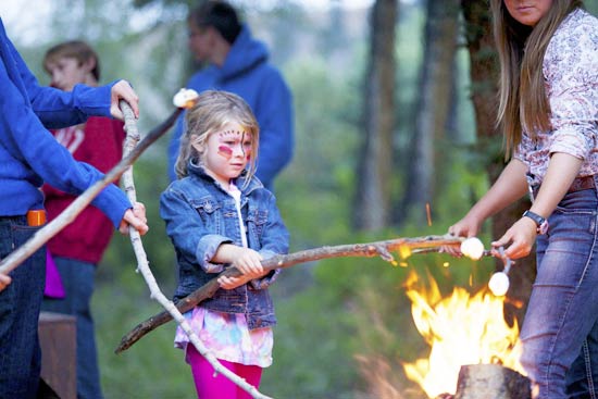 girl roasting marshmellow