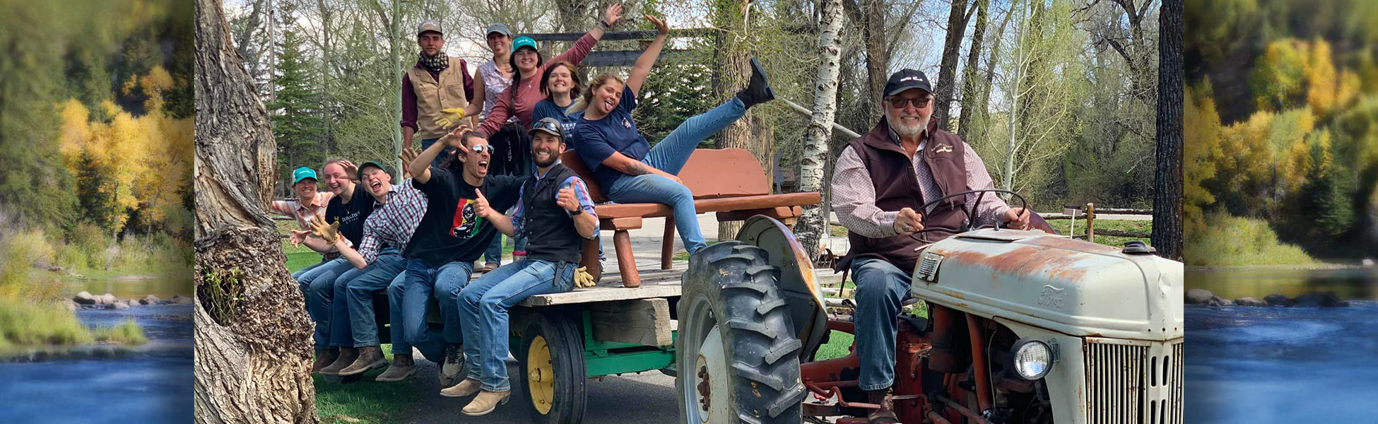 Staff riding on tractor with owner at the wheel