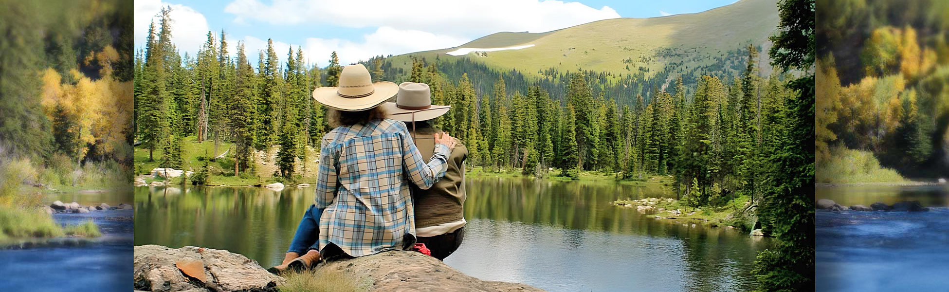 Two women sitting by lake