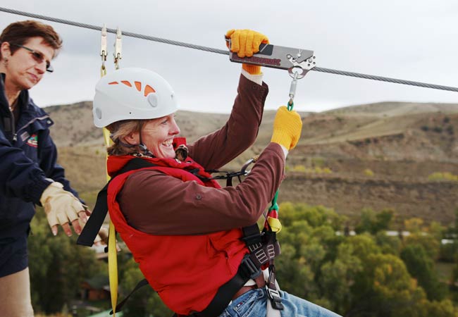 Women taking off of zip line