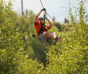 man red shirt on zip line